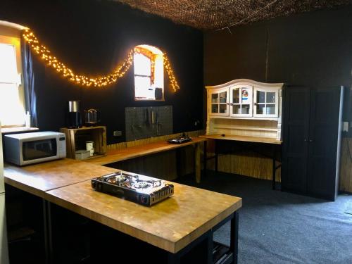 WerderKuckunniwi Tipidorf的厨房配有带微波炉的柜台和桌子。