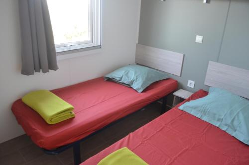 卢米奥chez Jean-Marc的小房间设有两张床和窗户