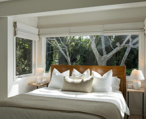 MontecitoPalm Cottage的一间卧室设有一张大床和大窗户