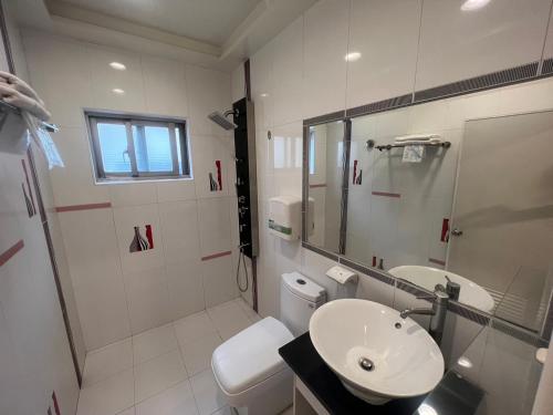 垦丁大街艾比莎渡假旅店二馆的白色的浴室设有水槽和卫生间。