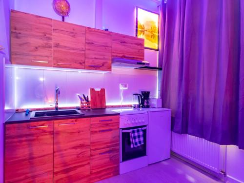诺伊斯#222 Modernes City Apartment im Herzen von Neuss的厨房配有木制橱柜和白色炉灶烤箱。