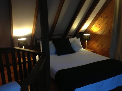 楠立比阳德拉普瀑布成人休闲酒店的一间卧室配有一张床和一张带两盏灯的婴儿床。