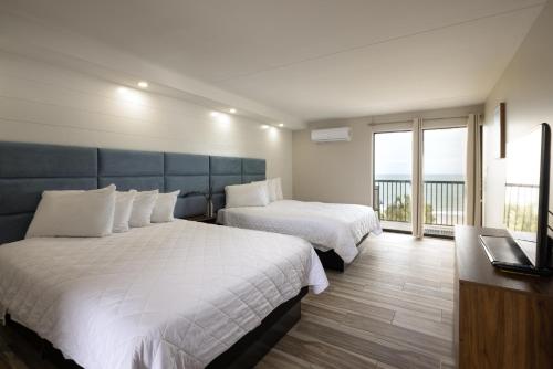 默特尔比奇Aventura on the Ocean的酒店客房设有两张床和一个阳台。
