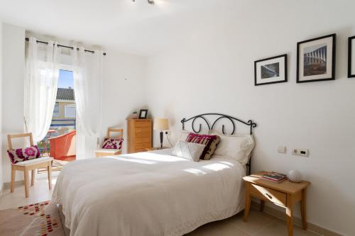 奥里韦拉斯科斯塔CB Living - Apartment with roof terrace Aguamarina的卧室设有一张白色大床和一扇窗户。
