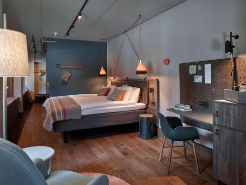 斯德哥尔摩斯堪迪克坎佩尔市区酒店的一间卧室配有一张床和一张桌子及椅子