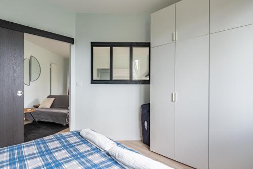 第戎"Le Marmuzot" - Confort - Calme - Parking Free的卧室配有白色橱柜和1张床。