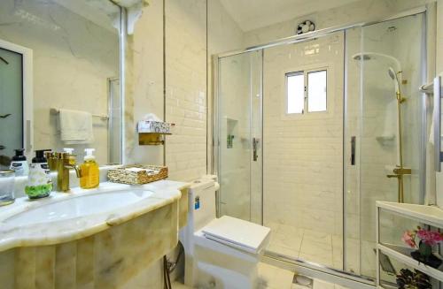 SanadLuxury Private Pool Villa for families only的带淋浴、水槽和玻璃淋浴间的浴室