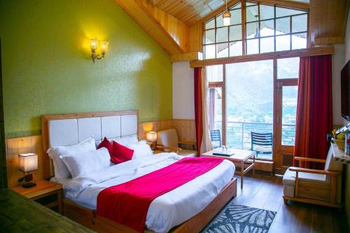 马拉里Hotel Seven Hills Manali的一间卧室设有一张大床和一个大窗户