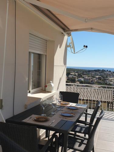 卡拉费尔Precioso apartamento con vista al mar的阳台上配有一张黑色的桌子和椅子