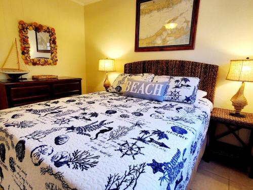 马纳索塔基Suite 3的一间卧室配有一张带蓝白色毯子的床