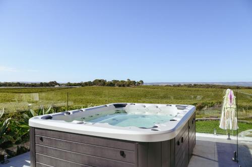 麦克拉伦谷Miravino – breathtaking vineyard views的庭院内的热水浴池,享有田野美景