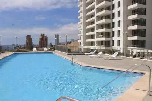 伊基克ALTOS DE HUAYQUIQUE的大型公寓大楼旁的大型游泳池