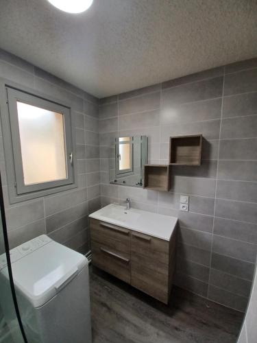 丰罗默奥代洛维亚Les Sorbiers - Grand T4 ensoleillé avec Vue Panoramique的一间带水槽、卫生间和镜子的浴室