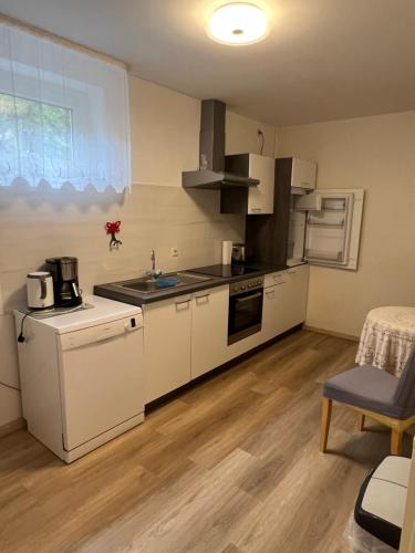 卡斯特劳恩利迪娅度假公寓的一间配备有白色家电和桌子的小厨房