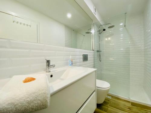 夫塞塔Tia Anica House I - apartment with terrace in central Fuseta beach village的白色的浴室设有水槽和卫生间。