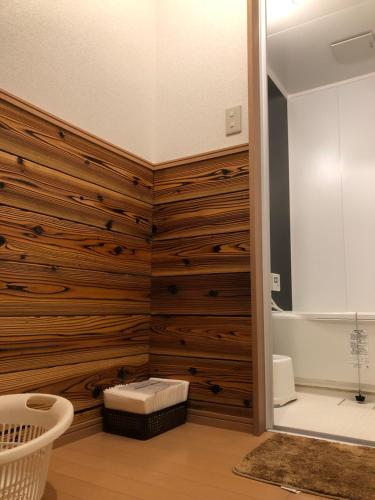 NosegawaMinshuku Kawarabi-so的一间带木镶板墙和浴缸的浴室