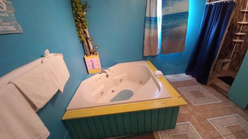 DuncansCastaways Villa的带浴缸的浴室和蓝色的墙壁