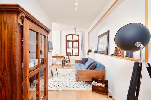 莱比锡casanando - LaMaison - neu saniert in ruhiger Innenstadtlage的客厅配有蓝色的沙发和桌子