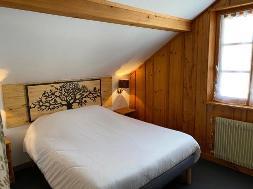 Lac des Rouges TruitesDomaine du Bugnon的卧室配有白色的床和窗户。
