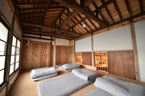 桐生市Dive INN Kiryu的带窗户的客房内设有三张床。