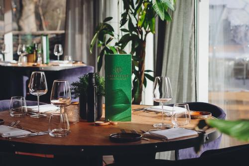 兰德赫拉夫高级庄园住宿的一张桌子,上面放着酒杯和绿盒子
