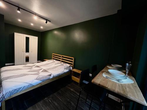 MoineştiStudio G1的一间卧室配有床和一张木桌,上面有盘子