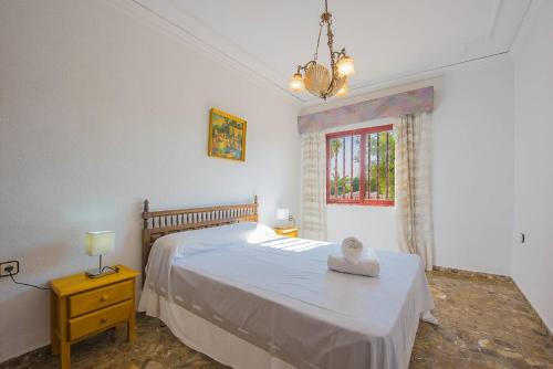 卡尔佩Villa Lina - PlusHolidays的卧室配有白色的床和窗户。