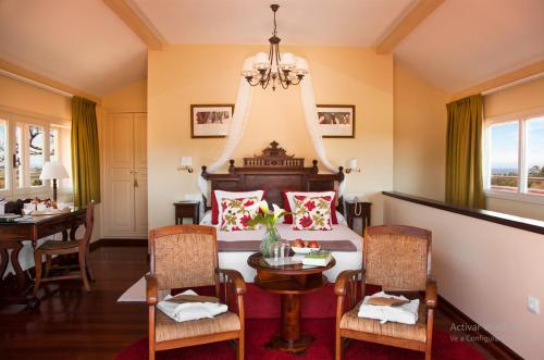 库迪列罗帕卡庄园酒店的卧室配有一张床和一张桌子及椅子