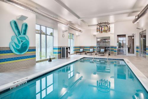 罗维莎Aloft Lawrenceville Sugarloaf的游泳池位于带游泳池的大房间