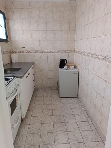 里奥加耶戈斯Hermoso departamento en Rio Gallegos的小厨房配有炉灶和冰箱