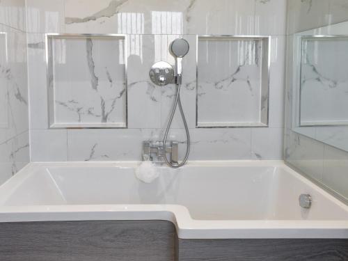 锡厄姆The Hawthorns的带淋浴的白色浴缸和2扇窗户。