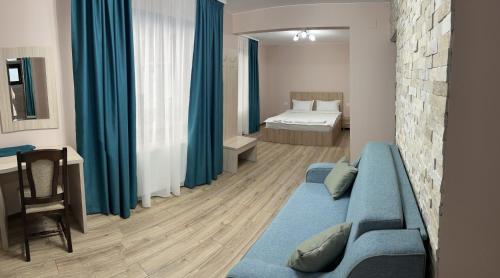 阿祖加Casa TimEva Azuga的一间带蓝色沙发的客厅和一间卧室