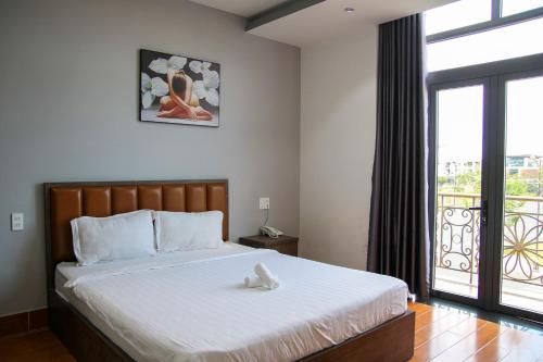 Ấp Rạch MẹoHAPPY HOTEL Kien Giang的一间卧室设有一张床和一个大窗户