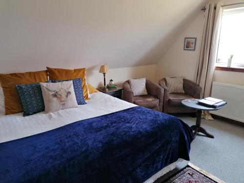 波特里Balmoral Skye的一间卧室配有一张带蓝色毯子的大床