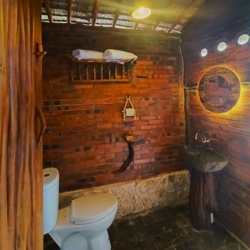 KemadangAma Awa Resort的一间带卫生间和砖墙的浴室