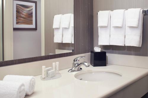 独立市克利夫兰独立万怡酒店的浴室配有盥洗盆、镜子和毛巾