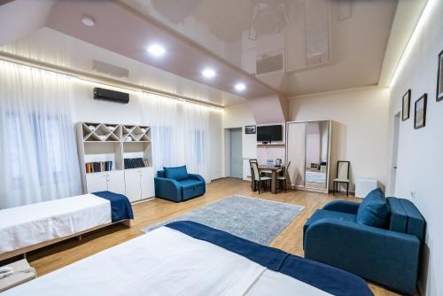 第比利斯第比利斯酒店的一间卧室配有两张床、一张沙发和一张桌子
