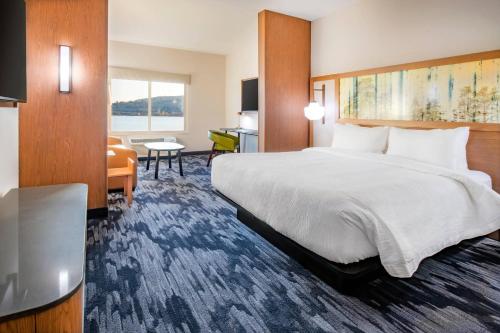 克拉马斯福尔斯Fairfield Inn & Suites by Marriott Klamath Falls的酒店客房设有一张大床和一张书桌。