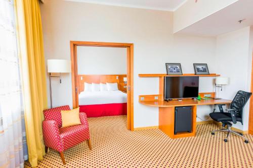 比尔森比尔森万怡酒店的酒店客房配有一张床和一张书桌及一台电视