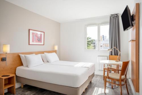 克雷泰伊塞祖尔阿菲尔克雷特尔玛吉斯特尔酒店的一间酒店客房,配有一张白色的床和一张书桌
