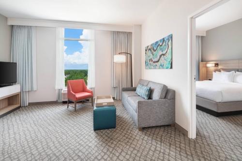 巴拿马城海滩SpringHill Suites by Marriott Panama City Beach Beachfront的酒店客房配有床、沙发和椅子
