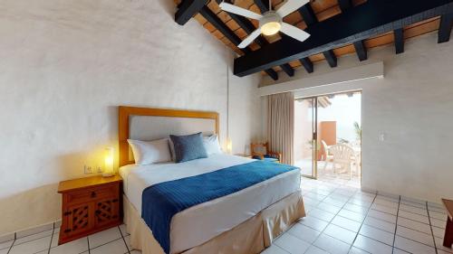 巴亚尔塔港Park Royal Homestay Los Tules Puerto Vallarta的一间卧室配有一张带吊扇的床