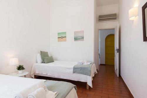 维拉摩拉Aldeia do Golfe - Private condominium by HD的一间小房间,设有两张床和走廊