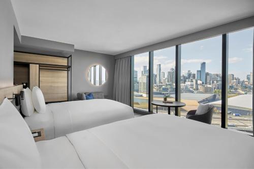 墨尔本AC Hotel by Marriott Melbourne Southbank的酒店客房,设有两张床,享有城市美景。