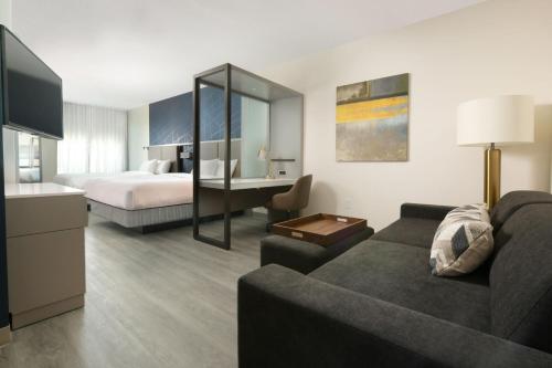 LindaleSpringHill Suites by Marriott Lindale的酒店客房设有一张沙发和一张床