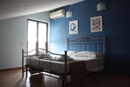 阿奇雷亚莱Casaci的一间卧室配有一张蓝色墙壁的床