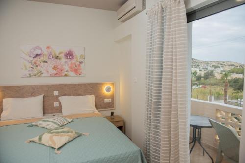 马塔拉Tsaner Apartment and Rooms的一间卧室设有一张床和一个大窗户
