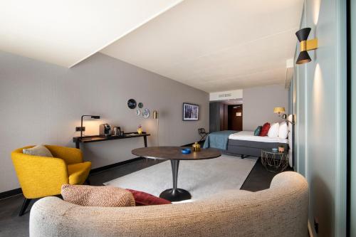阿珀尔多伦彼尔德伯格酒店的客房设有床、沙发和桌子。