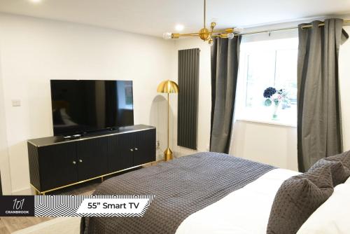 米尔顿凯恩斯Newly Refurbished Luxury Hotel Style Accommodation的一间卧室配有一张床和一台平面电视