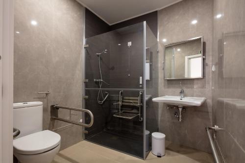 里斯本The ICONS Lisbon Central Hotel的带淋浴、卫生间和盥洗盆的浴室